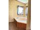 Bathroom features a cozy bathtub, floral wallpaper, and a window with charming curtains at 13080 Philadelphia Church Rd, Oakboro, NC 28129