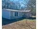Charming single-story home featuring a light blue exterior, white trim, and a fenced yard at 13080 Philadelphia Church Rd, Oakboro, NC 28129