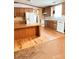 Kitchen with wooden cabinets, white appliances, and bar seating at 13080 Philadelphia Church Rd, Oakboro, NC 28129