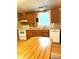 Features a functional kitchen with wood cabinets, laminate countertops, and essential appliances at 13080 Philadelphia Church Rd, Oakboro, NC 28129