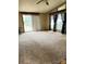 Bright and spacious living room with large windows and a sliding door at 13080 Philadelphia Church Rd, Oakboro, NC 28129