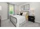 This bedroom features a metal bed frame, soft carpet, and a bright window that brings natural light at 145 Shepherds Landing Dr, Mooresville, NC 28115