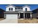Charming two-story home with a two-car garage, stone accents, and a well-manicured front lawn at 145 Shepherds Landing Dr, Mooresville, NC 28115