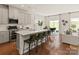 Open-concept kitchen with a large island, stainless steel appliances, and hardwood floors at 145 Shepherds Landing Dr, Mooresville, NC 28115