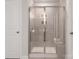 Modern tiled shower with a glass door and built-in shelving at 145 Shepherds Landing Dr, Mooresville, NC 28115