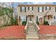 Charming townhome featuring a welcoming entrance with wooden steps and manicured landscaping at 1461 Flintwood Dr, Rock Hill, SC 29732