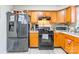 Kitchen view showcasing stainless steel refrigerator, range, and wood cabinets at 1465 Flintwood Dr, Rock Hill, SC 29732