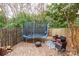 Backyard features a trampoline, comfortable seating around a cozy fire pit, and privacy fence at 1469 Flintwood Dr, Rock Hill, SC 29732