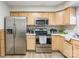 Spacious kitchen with stainless steel appliances, wooden cabinets, and a modern stovetop at 1469 Flintwood Dr, Rock Hill, SC 29732