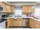 Well-lit kitchen featuring wooden cabinets, stainless steel appliances, and a clean white countertop at 1469 Flintwood Dr, Rock Hill, SC 29732