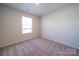 Bright and airy bedroom featuring a large window and neutral carpeting at 1760 Braemar Village Dr, Monroe, NC 28110