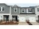 Charming two-story townhome featuring gray siding, a one-car garage, and well-maintained landscaping at 1760 Braemar Village Dr, Monroe, NC 28110
