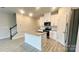 Bright kitchen features a center island, granite countertops, stainless steel appliances, and ample cabinet space at 1760 Braemar Village Dr, Monroe, NC 28110