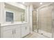 Modern bathroom with double vanity, white cabinets, large mirror, and a glass-enclosed shower at 1762 Braemar Village Dr, Monroe, NC 28110