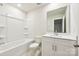 Well-lit bathroom featuring a tub and shower, white vanity, and modern fixtures for a fresh feel at 1762 Braemar Village Dr, Monroe, NC 28110