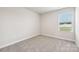 Clean, neutral-toned bedroom with a window letting in ample light, creating a calm, inviting space at 1762 Braemar Village Dr, Monroe, NC 28110
