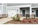 Inviting townhome with a one-car garage, brick accents, and a cozy front entrance at 1762 Braemar Village Dr, Monroe, NC 28110