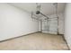 A spacious garage with a clean concrete floor and an automatic door opener, ready for use at 1762 Braemar Village Dr, Monroe, NC 28110
