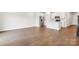 Bright, open concept living room with hardwood floors seamlessly flowing into a modern kitchen space at 1762 Braemar Village Dr, Monroe, NC 28110
