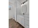 Modern bathroom with white cabinetry, quartz countertops, and contemporary lighting at 1828 Haines St, Charlotte, NC 28216