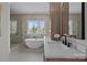 Modern bathroom features a soaking tub, large window, glass enclosed shower, and sleek vanity at 1828 Haines St, Charlotte, NC 28216