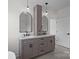 Modern bathroom featuring double sinks, sleek vanity, and decorative lighting fixtures at 1828 Haines St, Charlotte, NC 28216