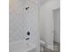 Modern bathroom features a tiled shower with black fixtures and a white vanity at 1828 Haines St, Charlotte, NC 28216