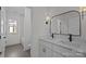 Bright bathroom featuring double sinks, sleek vanity, and decorative lighting fixtures at 1828 Haines St, Charlotte, NC 28216