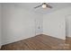 Neutral bedroom with hardwood floors, a ceiling fan, and trim on the walls at 1828 Haines St, Charlotte, NC 28216