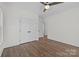 Empty bedroom with hardwood floors, double closets, and trim on the walls at 1828 Haines St, Charlotte, NC 28216