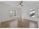 Open bedroom with hardwood floors, multiple windows, and trim on the walls at 1828 Haines St, Charlotte, NC 28216