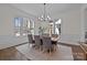 Bright dining room with large windows, modern chandelier, and stylish decor for elegant dining at 1828 Haines St, Charlotte, NC 28216