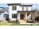 Charming two-story home with a covered front porch, landscaped yard, and modern design elements at 1828 Haines St, Charlotte, NC 28216