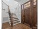 Elegant foyer featuring hardwood floors, paneled walls, and a staircase with iron railings at 1828 Haines St, Charlotte, NC 28216