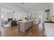 Open concept kitchen features hardwood floors, stainless appliances, and a kitchen island at 1828 Haines St, Charlotte, NC 28216