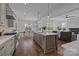 Open-concept kitchen with a large island, pendant lighting, and seamless flow into the dining and living areas at 1828 Haines St, Charlotte, NC 28216