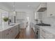 Bright kitchen features stainless appliances, marble backsplash, countertops, an island and wooden floors at 1828 Haines St, Charlotte, NC 28216