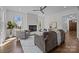 Comfortable living room features a fireplace, ceiling fan, and lots of natural light at 1828 Haines St, Charlotte, NC 28216