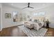 Bright main bedroom featuring hardwood floors, ceiling fan, a window view, and decor at 1828 Haines St, Charlotte, NC 28216