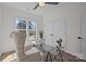 Office with a glass desk, patterned chair, and two windows at 1828 Haines St, Charlotte, NC 28216