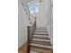 Staircase with wooden steps and iron railings, complemented by paneled walls at 1828 Haines St, Charlotte, NC 28216