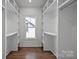 Spacious walk-in closet with built-in shelving and hardwood floors at 1828 Haines St, Charlotte, NC 28216