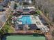 Community pool featuring a slide, lounge chairs, cabanas and a tennis court at 1874 Larkspur Way, Tega Cay, SC 29708