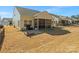 Backyard view featuring a patio, a screened-in porch, and grassy area at 1874 Larkspur Way, Tega Cay, SC 29708