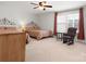 Spacious bedroom featuring two beds, a ceiling fan, neutral carpet and natural light from the window at 1874 Larkspur Way, Tega Cay, SC 29708