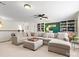 Spacious bonus room featuring a large sectional sofa and built-in bookshelves at 1874 Larkspur Way, Tega Cay, SC 29708