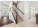 Welcoming entryway featuring hardwood floors, wainscoting, and a staircase at 1874 Larkspur Way, Tega Cay, SC 29708