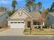 Charming home featuring a stone entryway, attached garage, and well-maintained landscaping at 1874 Larkspur Way, Tega Cay, SC 29708