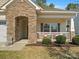 Close up of the home's stone entryway and inviting front porch with seating at 1874 Larkspur Way, Tega Cay, SC 29708
