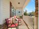 Side view of the front porch featuring rocking chairs and decorative accents at 1874 Larkspur Way, Tega Cay, SC 29708
